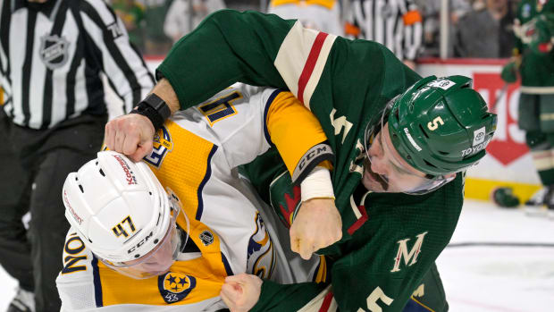 Nashville Predators forward Michael McCarron (47) and Minnesota Wild defenseman Jacob Middleton (5) fight during the second period at Xcel Energy Center in St. Paul, Minn., on Jan. 25, 2024.